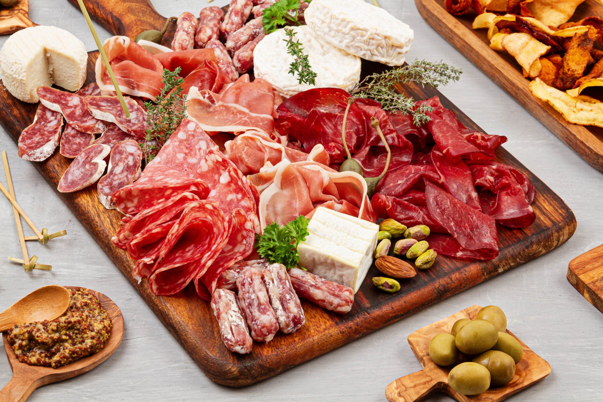 Charcuterie Board With Various Kinds Of Meat And Sausage